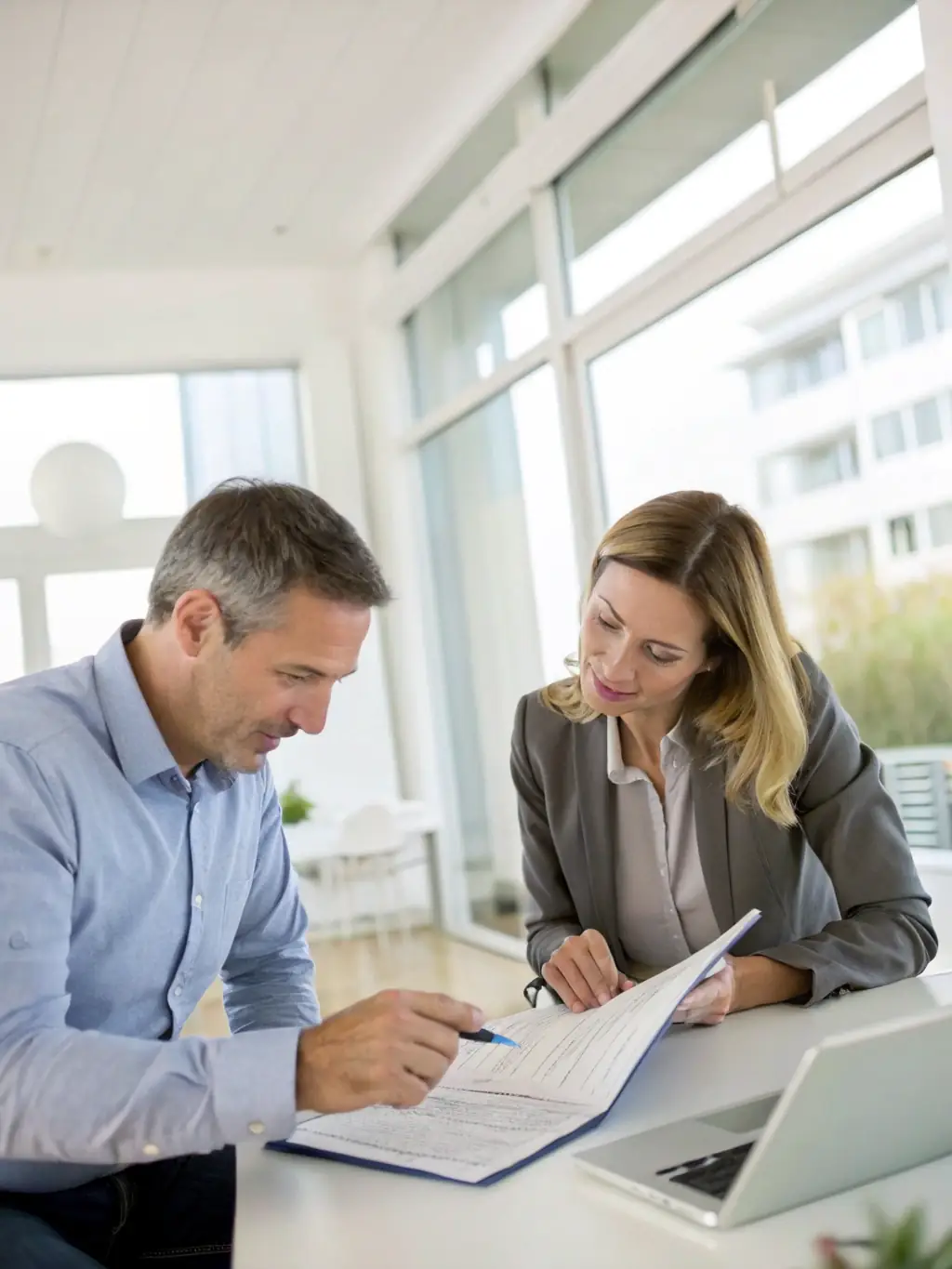 A photograph of a property manager interacting positively with a tenant, discussing lease terms and addressing concerns in a friendly and professional manner.